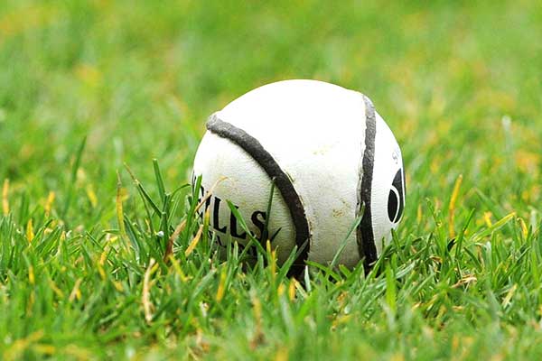 Sliotar resting on grass surface